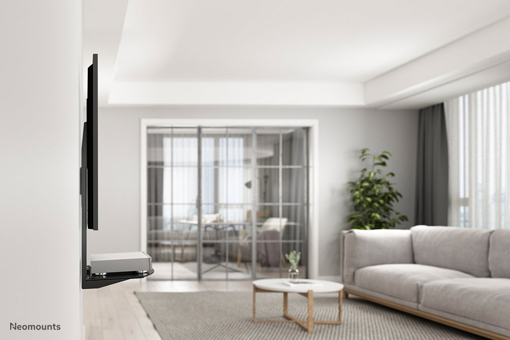 Neomounts AV-steun, model NS-SHELF100 is ideaal voor het plaatsen van AV-apparatuur onder flat screen steunen.